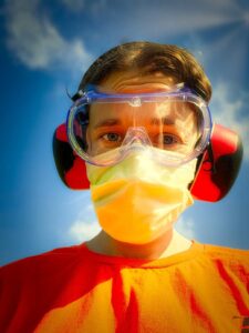 Ms. Grumpy Pants Plants wearing safety goggles, ear protection, and a surgical mask while removing poison hemlock from her acreage