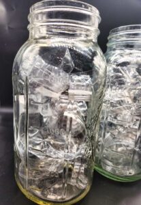 Half gallon mason jars with plastic water bottle strips inside