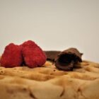 Waffle with homemade chocolate decor and fresh raspberries